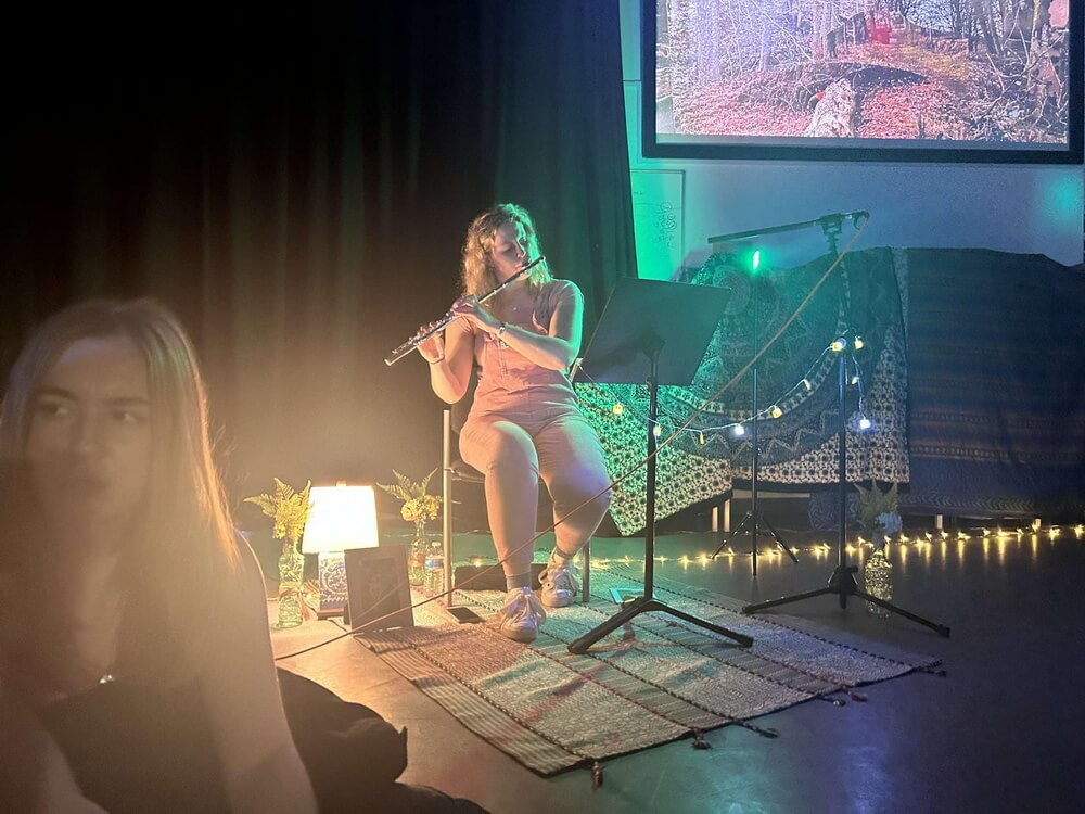 Selina at the drum kit wrapped in fairy lights