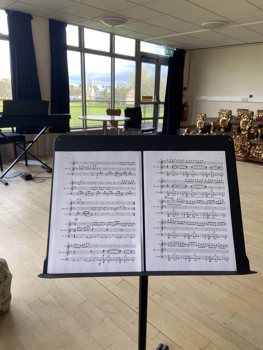 Arranged score for Solace on a music stand in the rehearsal room